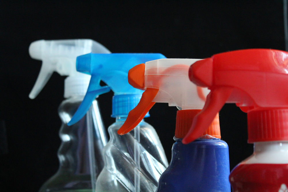 Four coloured spray bottles